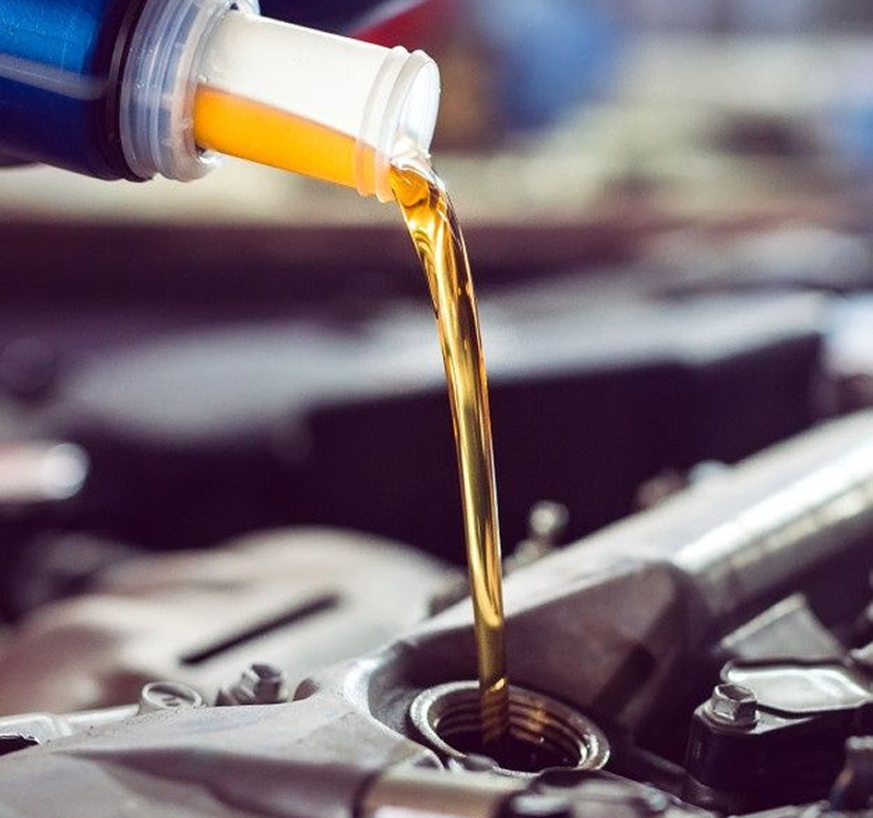 Engine oil being poured into a car engine