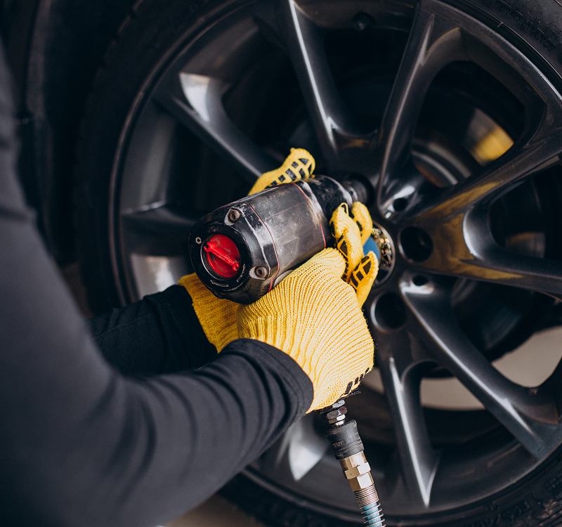 Car mechanic changing a car tyre
